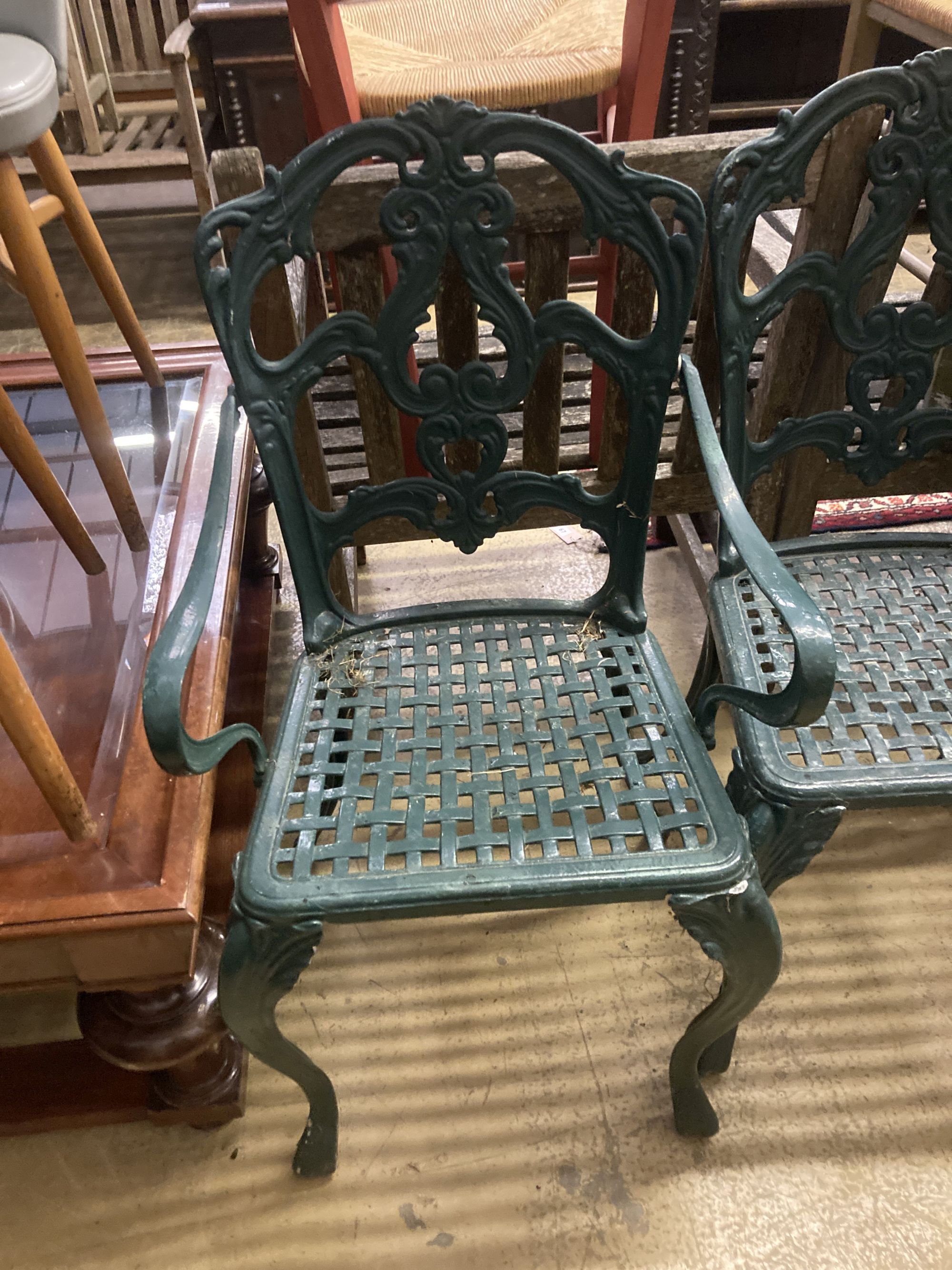 A set of four painted cast aluminium garden chairs (two with arms)